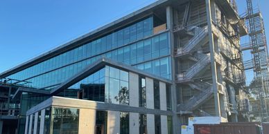 Modern glass office building with external staircases.