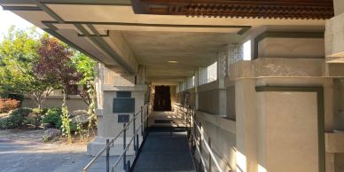 Covered walkway with a ramp leading into a building.