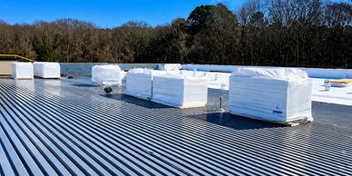 Commercial standing seam metal roof installation by Circle S Improvements.