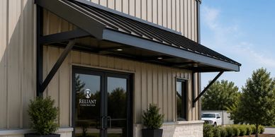 Custom metal awning installation providing weather protection and enhanced curb appeal for a commerc