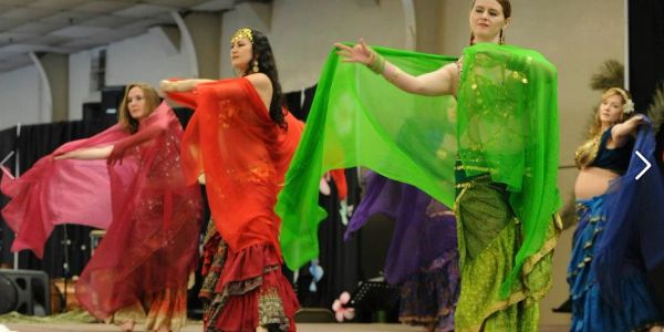 Women performing a colorful traditional dance.