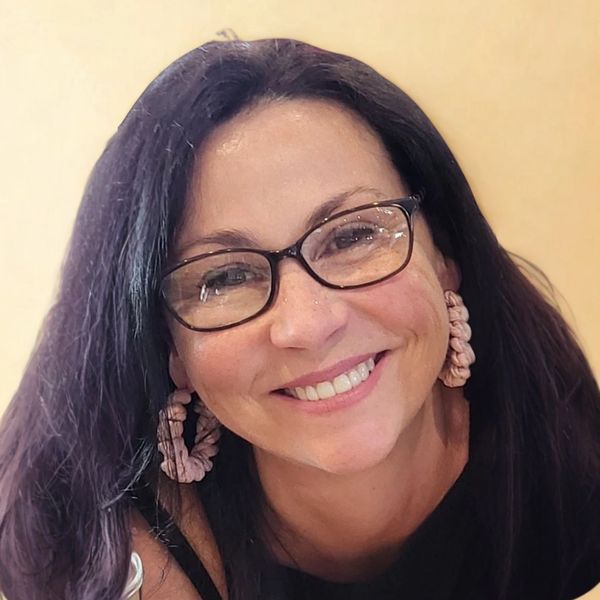 Photo of Alison smiling.