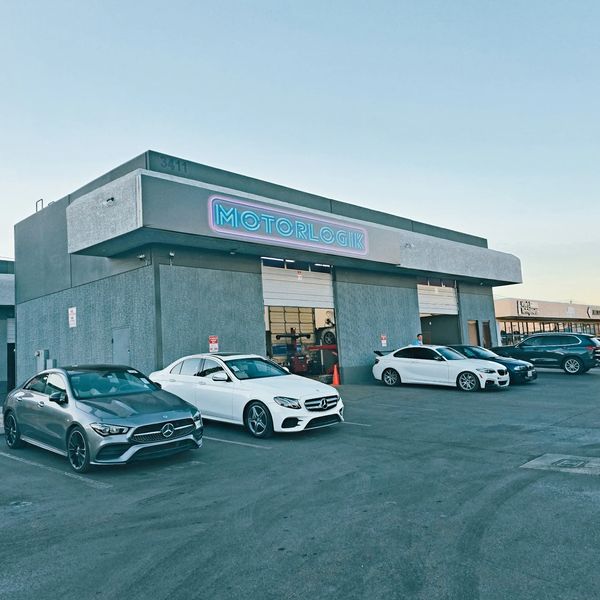 Cars parked outside Motorlogik repair shop.