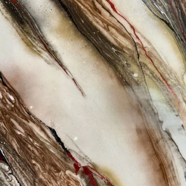 Brown and cream colored  stone with red vein accents.
