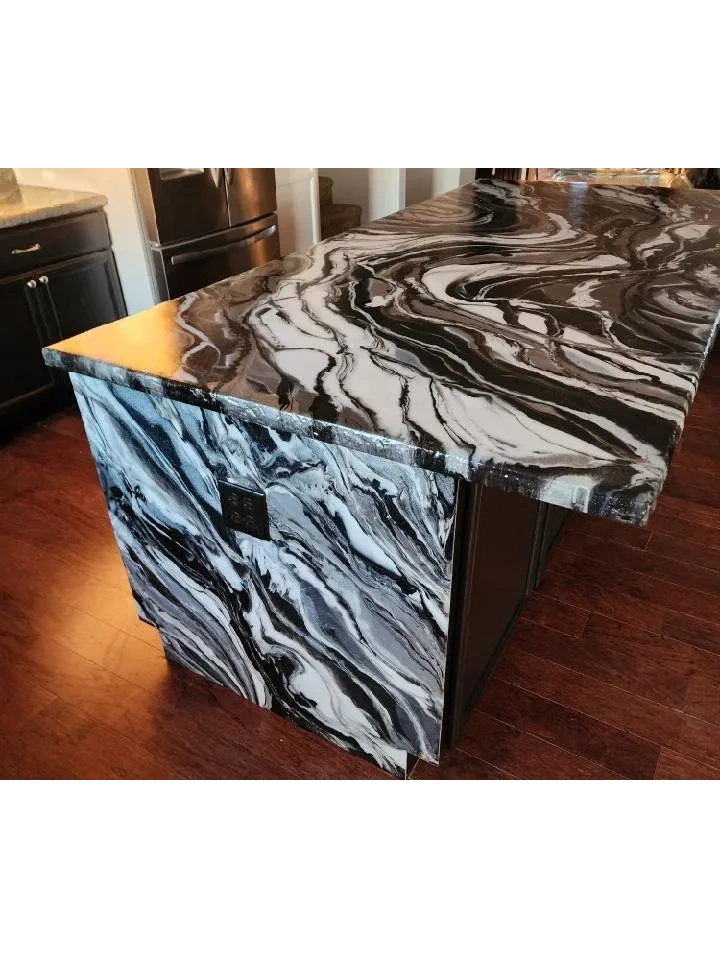 Black and white marble kitchen island with matching countertop and dark wood floor.