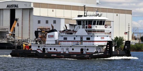 Tugboat named The Miss Vanessa in a harbor.