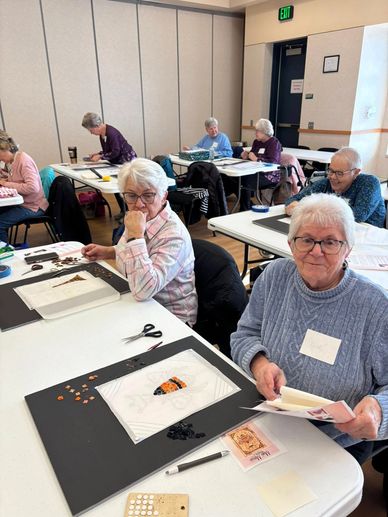 Senior women engaged in a crafting workshop at a community center.