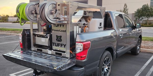 Pickup truck with Tuffy Hot Water Skid loaded on the back of truck.