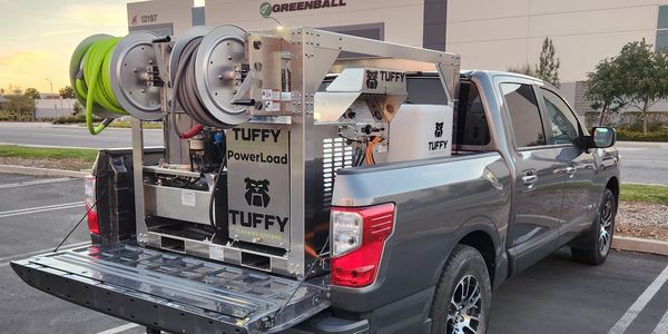 Pickup truck with Tuffy Hot Water Skid loaded on the back of truck.