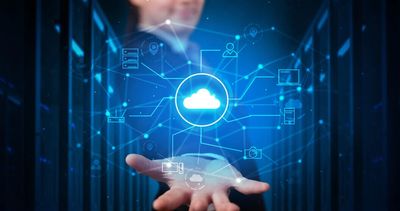 Person holding a digital cloud network hologram symbolizing cloud computing.