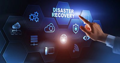 Hand pointing at digital interface with disaster recovery icons and technology symbols.