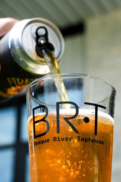 Beer being poured into a Bosque River Taphouse glass.