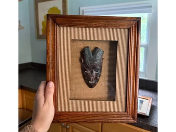 Home Goods tribal looking masks in shadow box frames.
