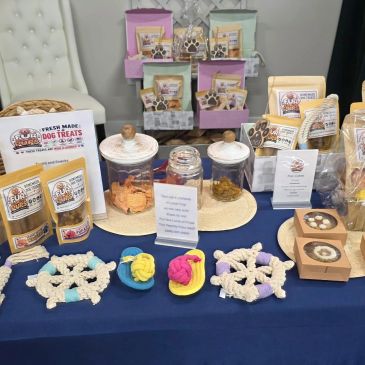 Display of various colorful dog treats and snacks on a table.