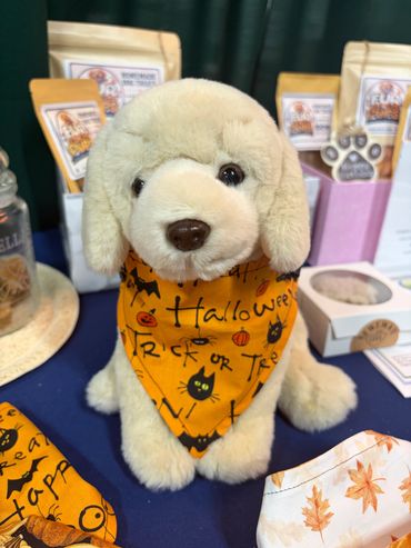 Fluffy stuffed dog with Halloween bandana.