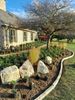 Planting with stone edge, boulders and landscape lights
