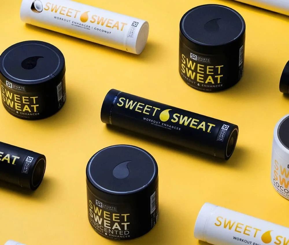 Sweet Sweat workout enhancer containers on a yellow background.