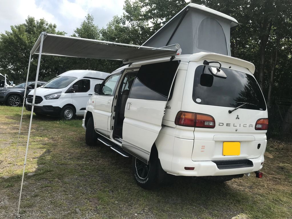 White Mitsubishi Delica with a Drivelodge elevating roof 