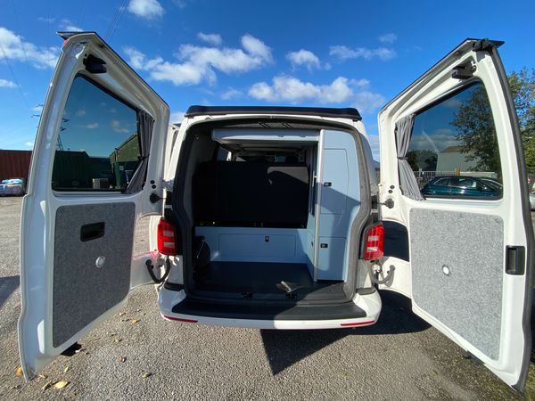 Volkswagen transporter campervan conversion view from the rear with cupboards and boot space