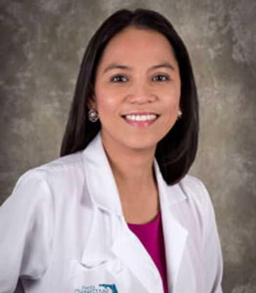 Woman in white medical coat smiling