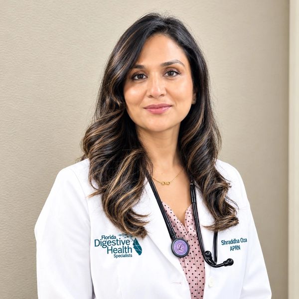 Portrait of a female healthcare professional in a white coat.