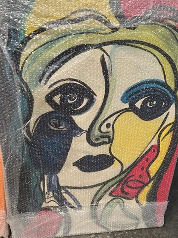 Abstract colorful face painting wrapped in bubble wrap.