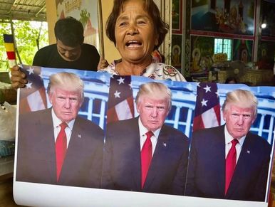 Villager holds a photo of US President Donald Trump in Prey Chan Village, in Cambodia border region.