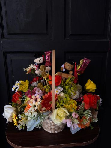 Colorful flower basket with teddy bears and chocolates.