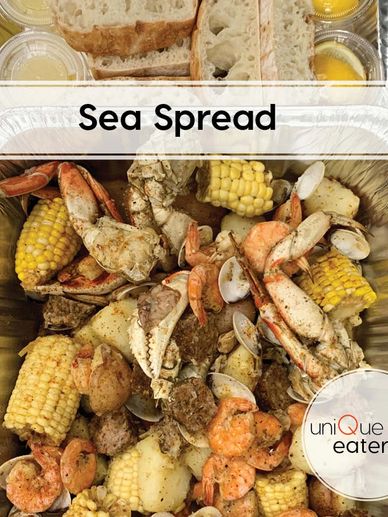 Seafood boil with crab, shrimp, corn, and potatoes.