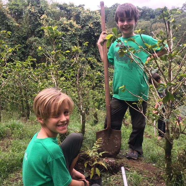 Two boys helping on a coffee plantation during a student tour in Costa Rica.