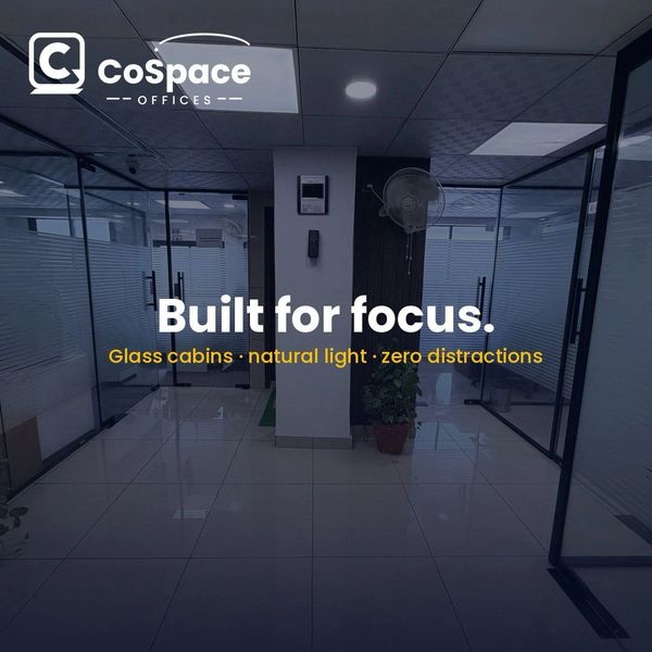 Modern office space with glass cabins and natural light.