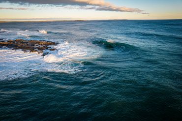 A wave breaking along the shore in midcoast Maine