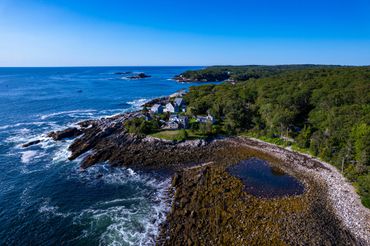 Tide pool next to coastal homes in midcoast Maine