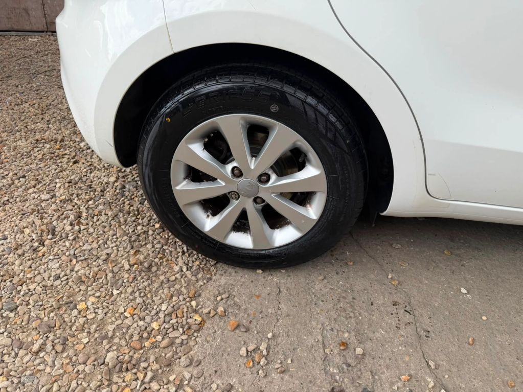 Close-up of a car's rear wheel and tire.
