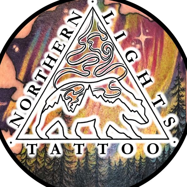 Northern Lights Tattoo logo with bear and forest design.