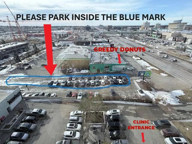 Aerial view of parking lot with blue marked area and labeled locations for Greedy Donuts and Clinic Entrance.