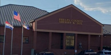 Exterior of Phelps County Sheriff &amp; Jail building with flags flying.