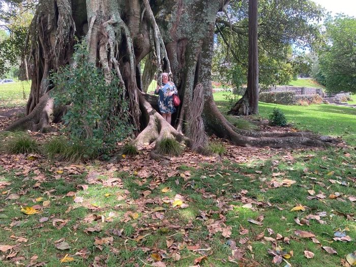 Larissa standing in front of a very large tree. 
