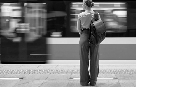 Lady at a train that is moving past her