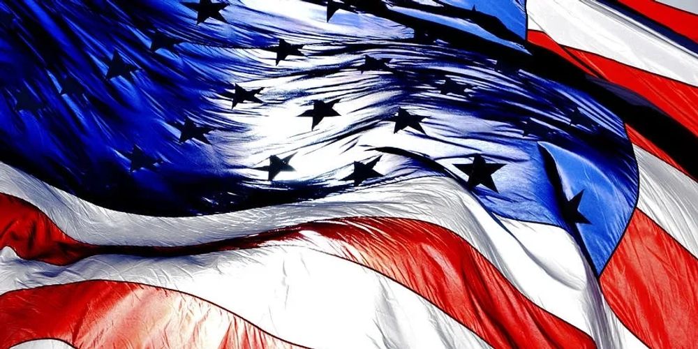 Close-up of a waving American flag with vibrant colors and visible texture.