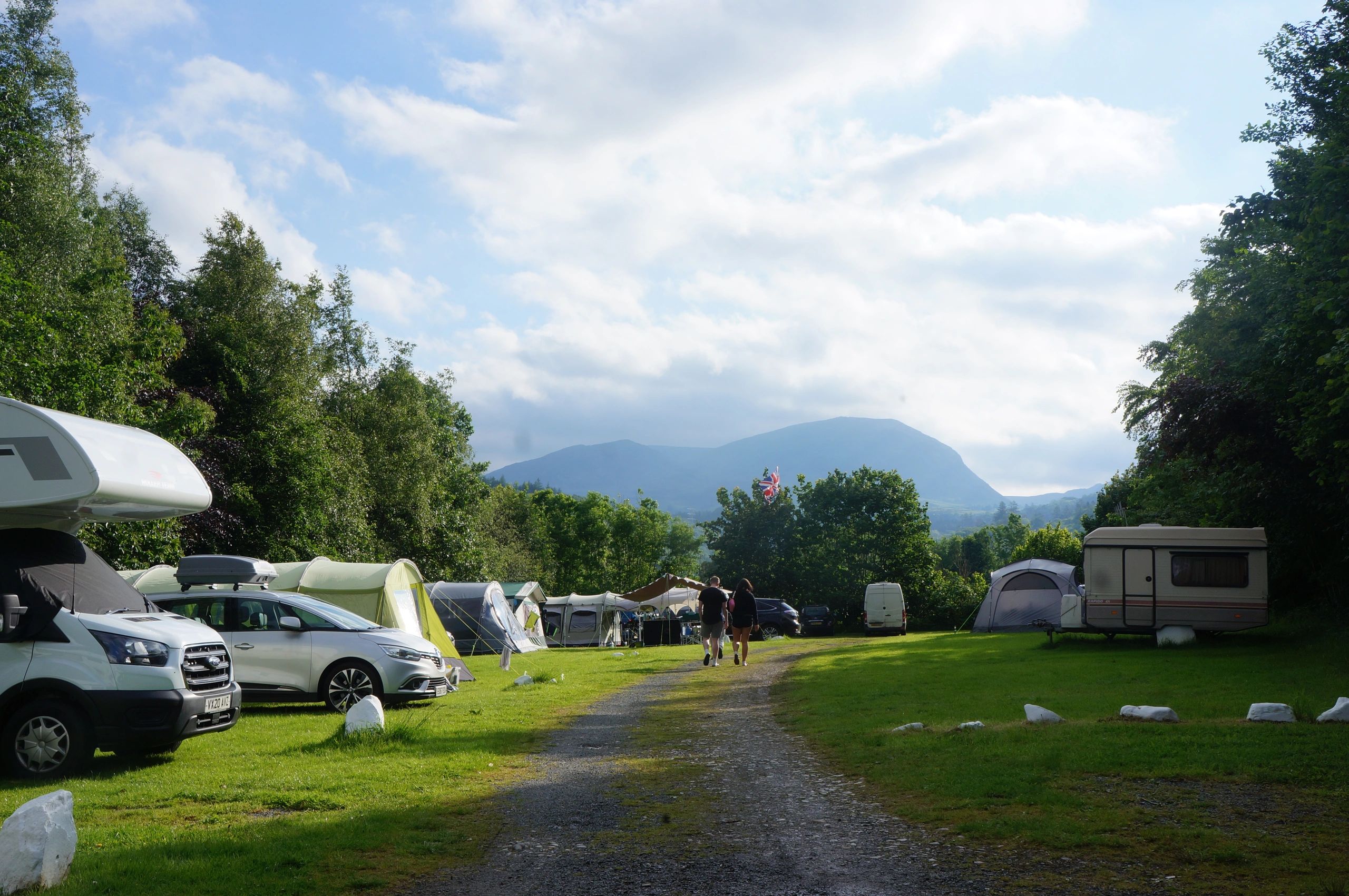 Tents, caravans and motorhomes on upper field with manod mountsins in background