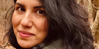 Close-up of a woman with dark hair smiling.