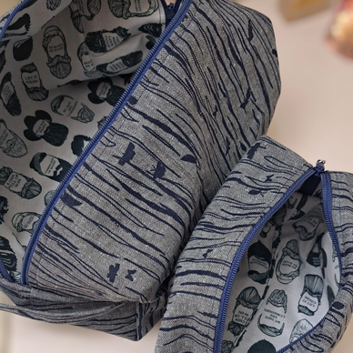 Two fabric pouches with blue zippers and unique patterns.