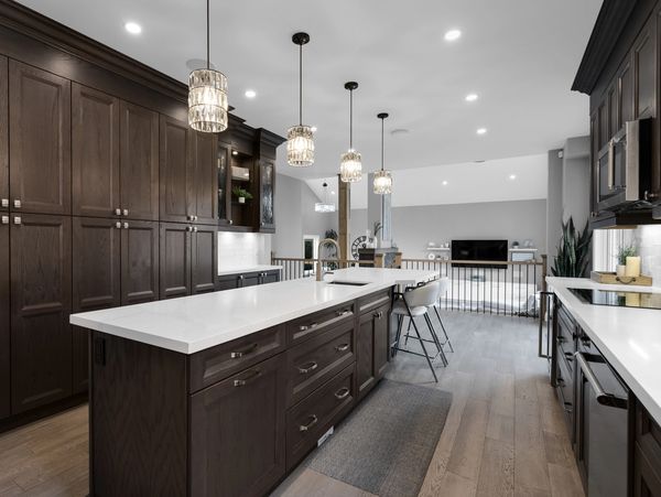 Modern kitchen in a custom built home in Tiny Township Ontario. Dark cabinets and quartz countertop.
