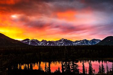 Sunset over dark mountain range.