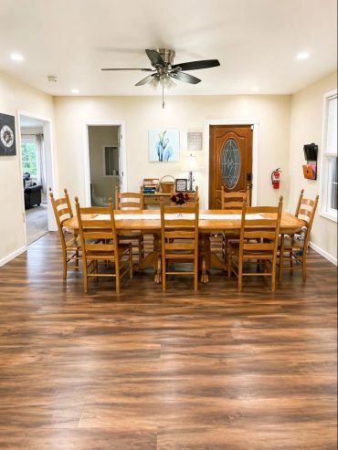 Dining room with wooden table and chairs.