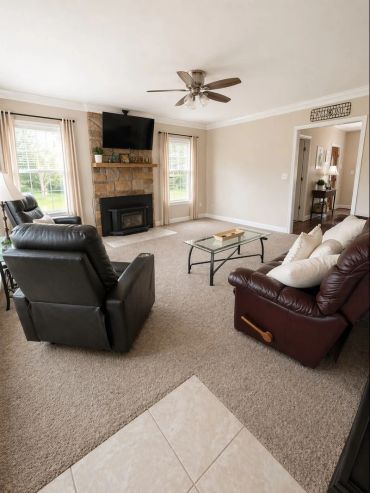 Cozy living room with recliners and fireplace.
