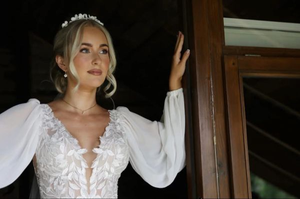 Bridal makeup on bride posed in doorway, looking into the distance