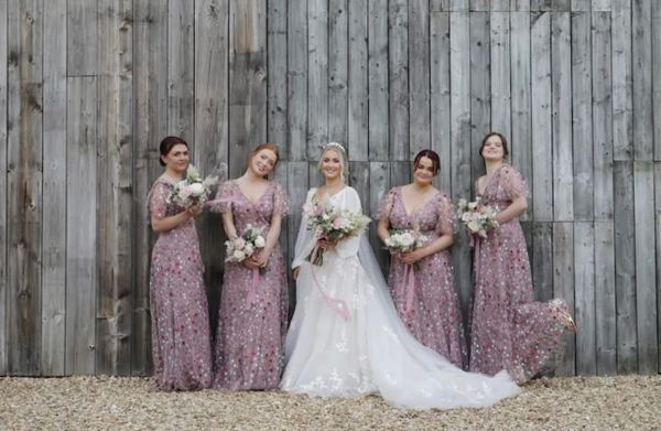 Bridal makeup on blonde Bride with four Bridesmaids in mauve floral dresses