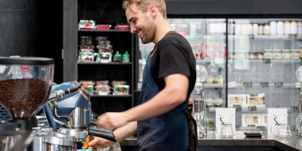A barista operating on their professional coffee machine.